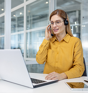 portrait of a young woman in a headset working in office